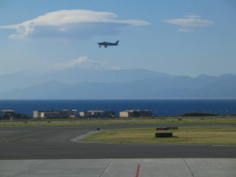 reggio calabria airport with straight of messina, sicily and snow covered mnt Etna in the background